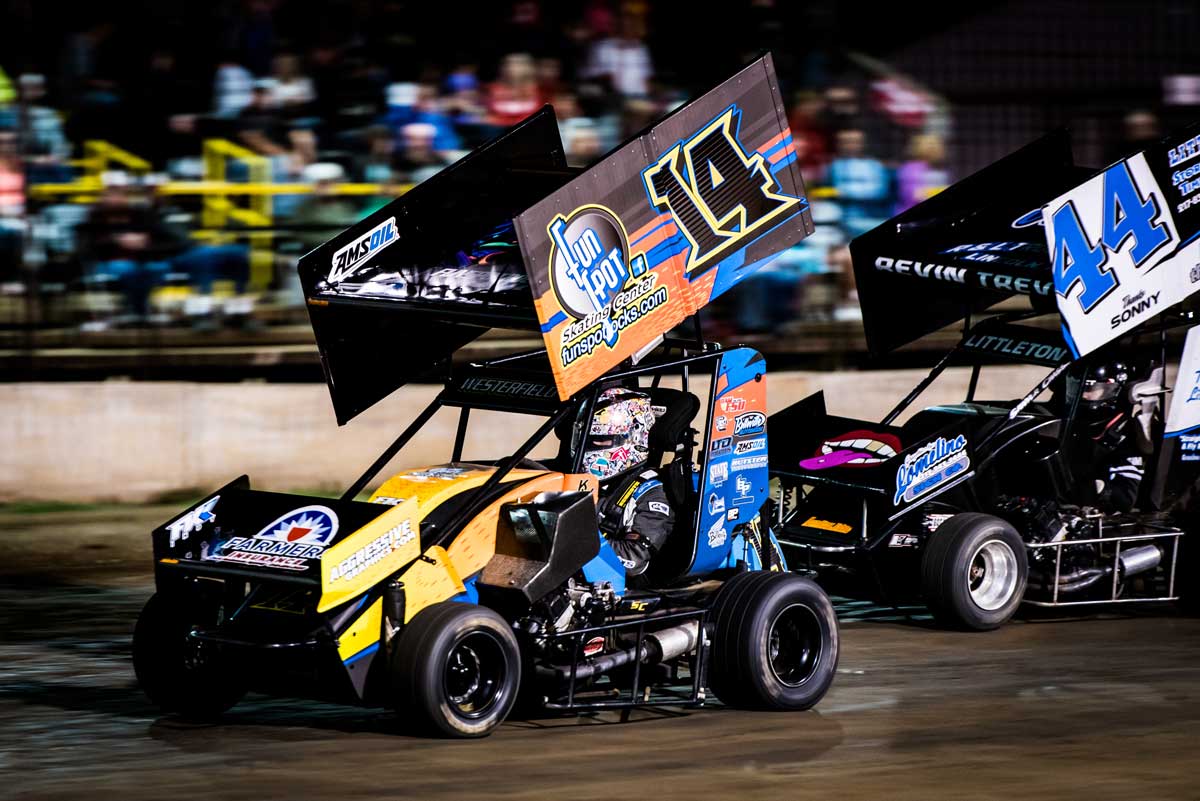 two stock cars racing at the Jacksonville Speedway